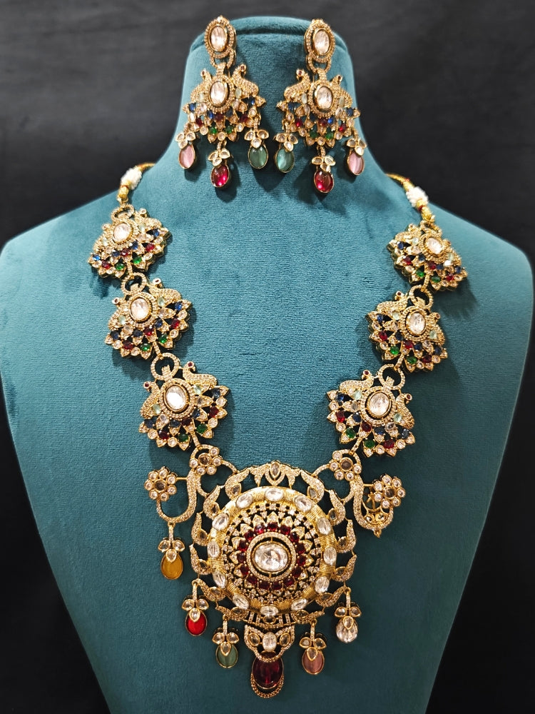 Close-up of an ornate traditional American diamond & Color stone gold jewellery set and earrings with American Diamond, Colored Stones, Kundan and Polki. A graceful trending American diamond necklace for a 2026 wedding celebration.