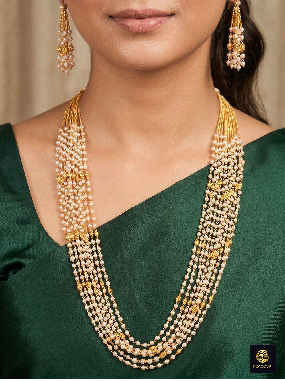 Close-up of a woman wearing an ornate traditional White Pearl Long Jewellery Set and Earrings with Pearl. Mehendi function outfit styled with a lightweight Pearl necklace. Festive saree look completed with a handcrafted Pearl necklace.