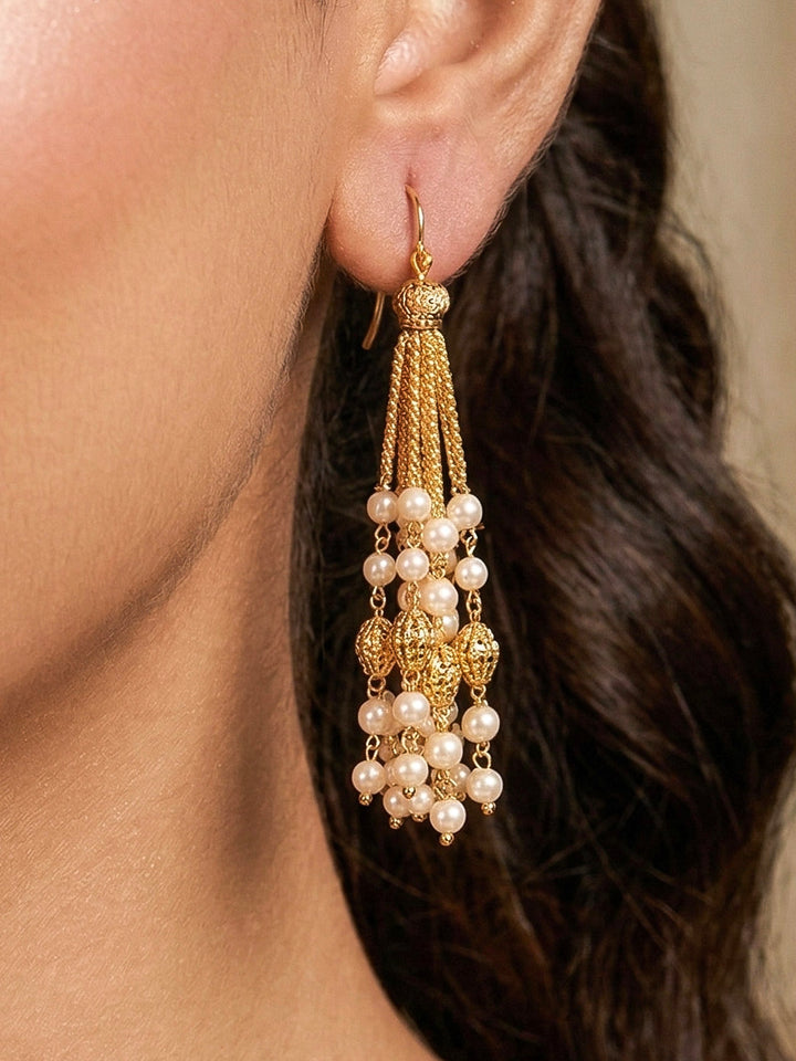 Close-up of a woman wearing an ornate traditional White Pearl Long Jewellery Set and Earrings with Pearl. Mehendi function outfit styled with a lightweight Pearl necklace. Festive saree look completed with a handcrafted Pearl necklace.