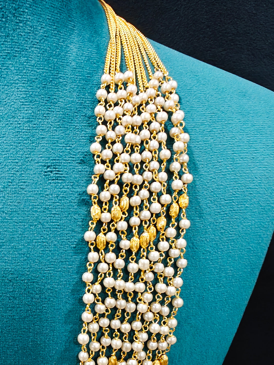 Close-up of an ornate traditional White Pearl Long Jewellery Set and Earrings with Pearl. Mehendi function outfit styled with a lightweight Pearl necklace. Festive saree look completed with a handcrafted Pearl necklace.
