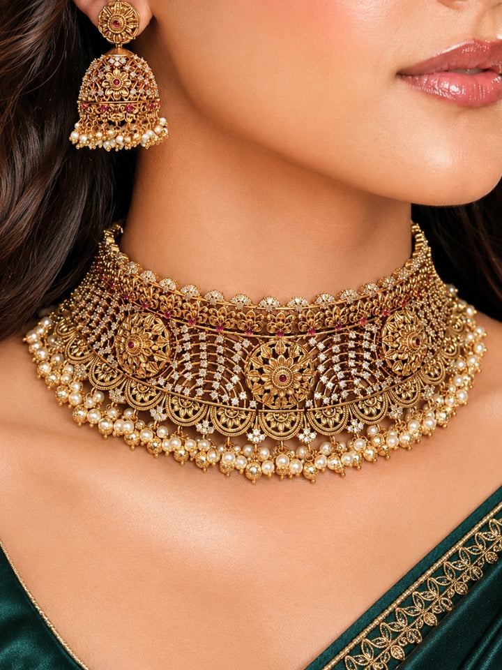 Close-up of a women wearing an ornate traditional (Gold Polish) Choker jewellery set and earrings with Pearls, American Diamond, Colored Stones. Wedding guest outfit enhanced with elegant artificial American Diamond jewelry Set. Close-up shot of a high-quality American diamond artificial necklace worn for festive celebrations.