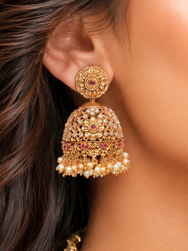 Close-up of a women wearing an ornate traditional (Gold Polish) Choker jewellery set and earrings with Pearls, American Diamond, Colored Stones. Wedding guest outfit enhanced with elegant artificial American Diamond jewelry Set. Close-up shot of a high-quality American diamond artificial necklace worn for festive celebrations.