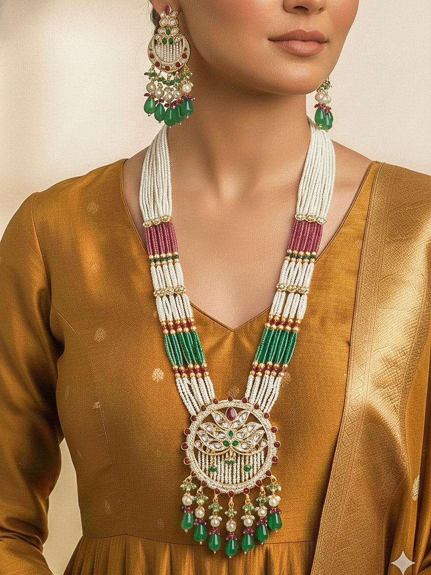 Close-up of a woman wearing an ornate traditional Mint Pink and Green Rajwadi gold Long jewellery set and earrings  with Pearls, Moissanite Kundan, Bandhai Work, Hydro Crystals and Tumble Beads. Mehendi ceremony look styled with a Rajwadi artificial jewelry set. Traditional Indian look featuring a Rajwadi necklace set.