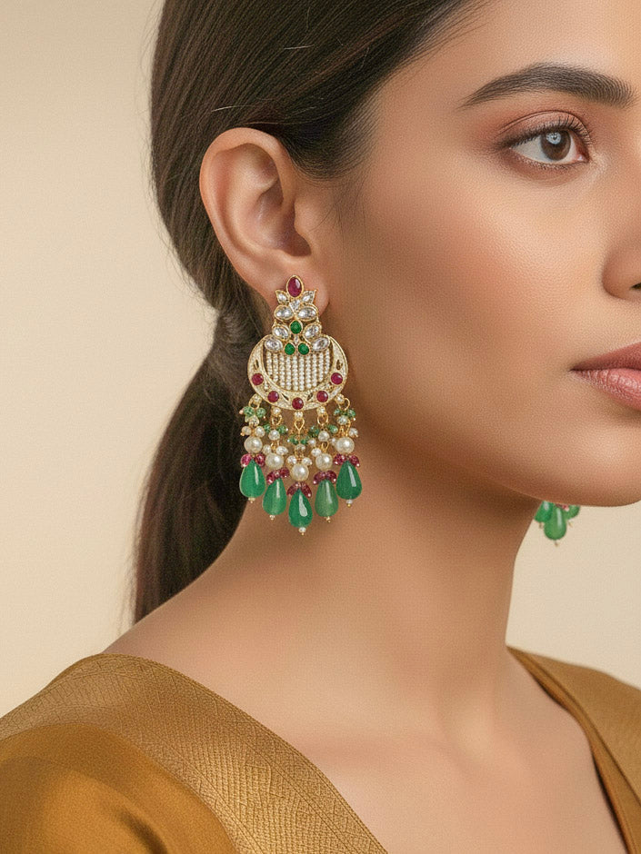 Close-up of a woman wearing an ornate traditional Mint Pink and Green Rajwadi gold Long jewellery set and earrings  with Pearls, Moissanite Kundan, Bandhai Work, Hydro Crystals and Tumble Beads. Mehendi ceremony look styled with a Rajwadi artificial jewelry set. Traditional Indian look featuring a Rajwadi necklace set.