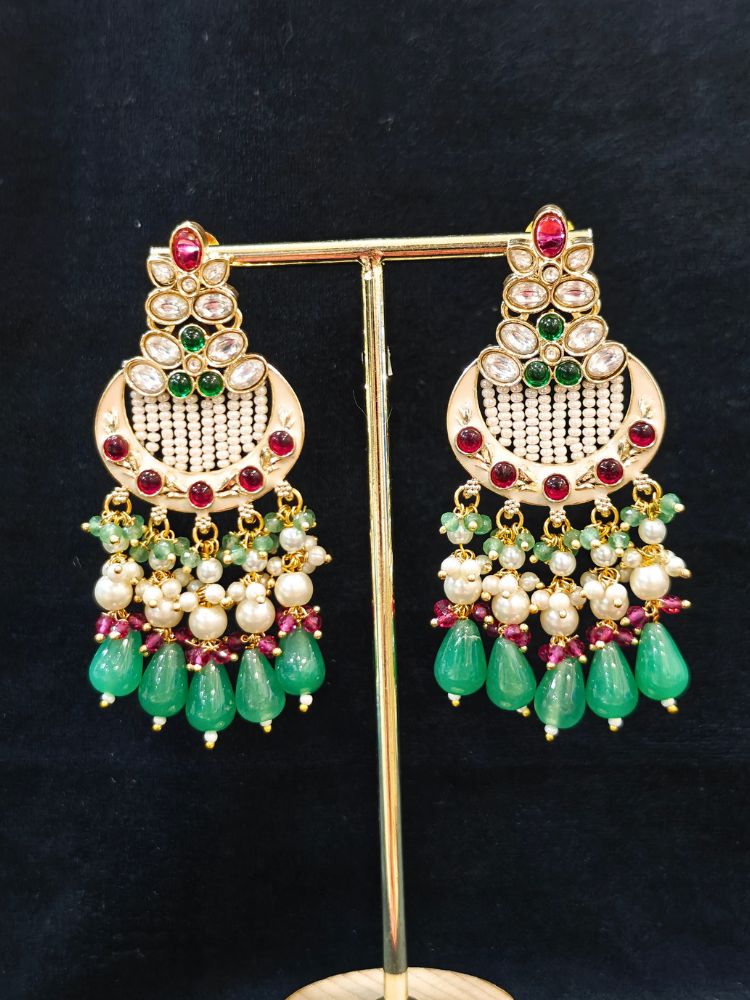 Close-up of an ornate traditional Mint Pink and Green Rajwadi gold Long jewellery set and earrings  with Pearls, Moissanite Kundan, Bandhai Work, Hydro Crystals and Tumble Beads. Mehendi ceremony look styled with a Rajwadi artificial jewelry set. Traditional Indian look featuring a Rajwadi necklace set.