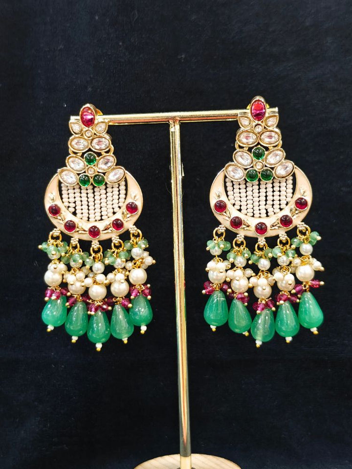 Close-up of an ornate traditional Mint Pink and Green Rajwadi gold Long jewellery set and earrings  with Pearls, Moissanite Kundan, Bandhai Work, Hydro Crystals and Tumble Beads. Mehendi ceremony look styled with a Rajwadi artificial jewelry set. Traditional Indian look featuring a Rajwadi necklace set.