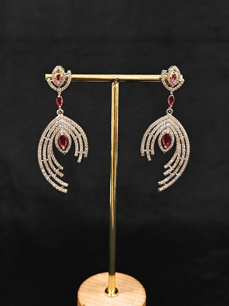 Close-up of an ornate Western (Silver Polish) Red Diamond  Earrings with American Diamond and Colored Stones. Party wear outfit completed with a lightweight American diamond Earrings. Close-up shot of a high-quality American diamond artificial Earrings worn for festive celebrations.