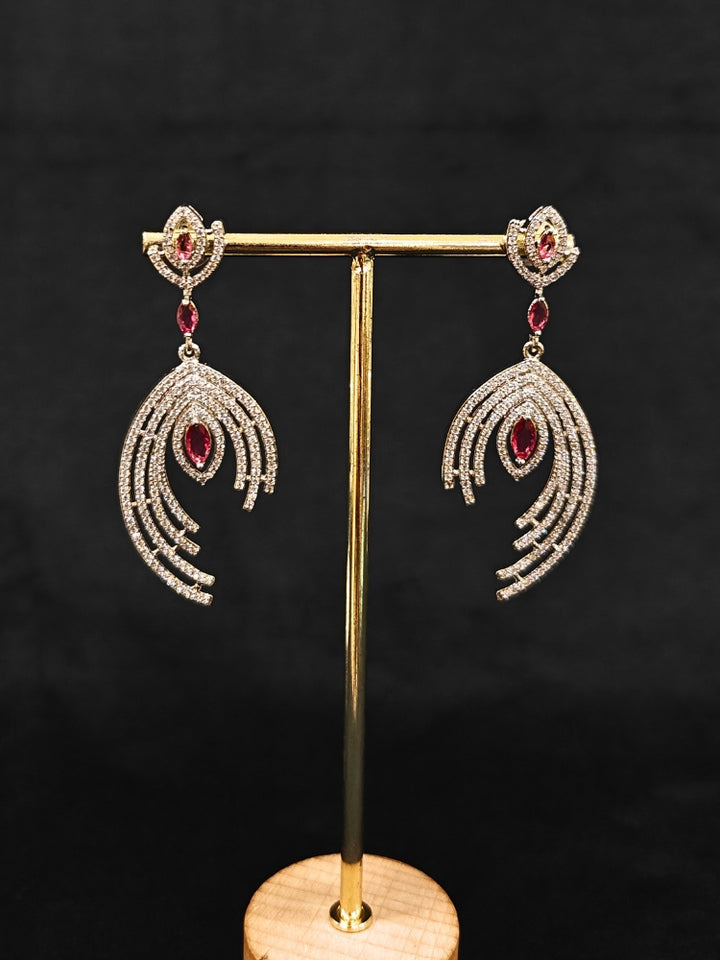 Close-up of an ornate Western (Silver Polish) Red Diamond  Earrings with American Diamond and Colored Stones. Party wear outfit completed with a lightweight American diamond Earrings. Close-up shot of a high-quality American diamond artificial Earrings worn for festive celebrations.