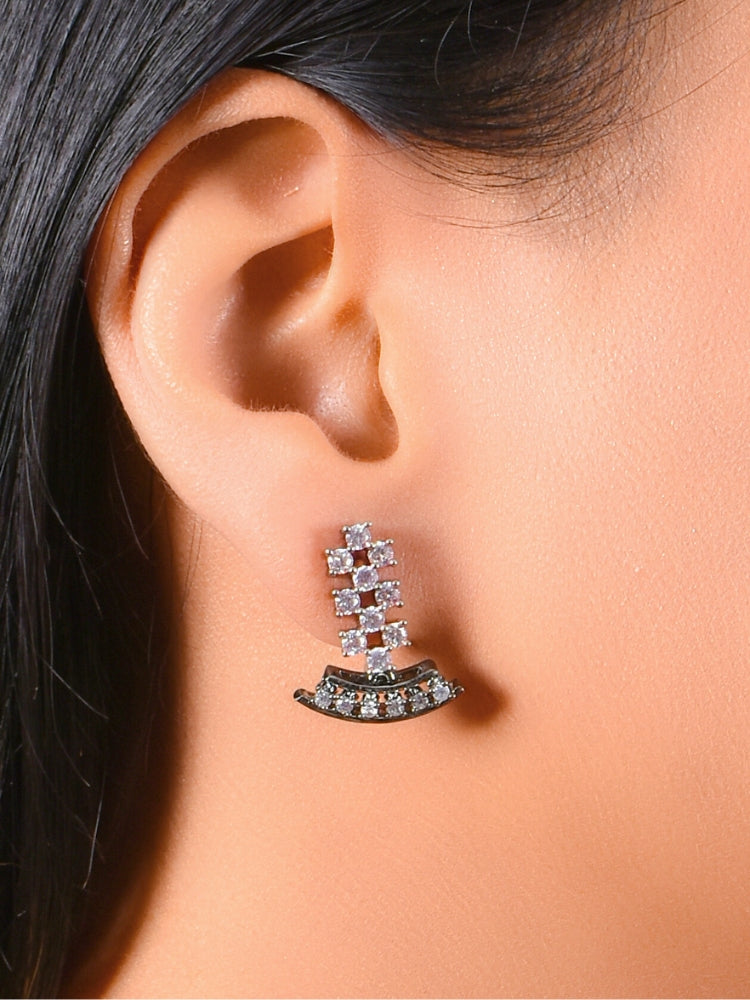 A woman showcases the Margaret Necklace Set, a matching American Diamonds jewelry set with a black polish necklace and earrings adorned with clusters of American diamonds and colored stones, elegantly set against her skin and dark hair.
