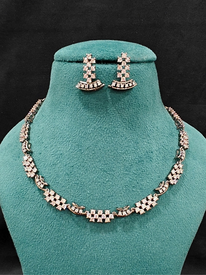 Close-up of an ornate Western (Black Polish Victorian Finish Polish) Black Diamond Necklace set and earrings with American Diamond. A premium Diamond artificial jewelry set for reception night. Elegant reception look featuring a luxury American Diamond artificial jewelry set.
