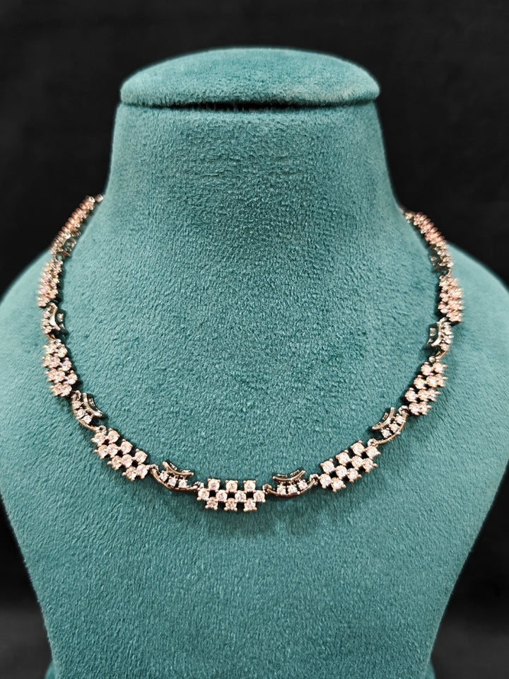 Close-up of an ornate Western (Black Polish Victorian Finish Polish) Black Diamond Necklace set and earrings with American Diamond. A premium Diamond artificial jewelry set for reception night. Elegant reception look featuring a luxury American Diamond artificial jewelry set.