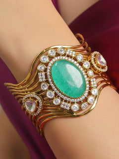 Close-up of a woman wearing an ornate traditional Mint Green (gold Polish) Colored Stone Bracelet with American Diamond, Colored Stones and Kundan. Festive outfit paired with a premium imitation Colored Stone bracelet in India. Wedding guest wearing a minimal artificial Colored Stone bracelet.