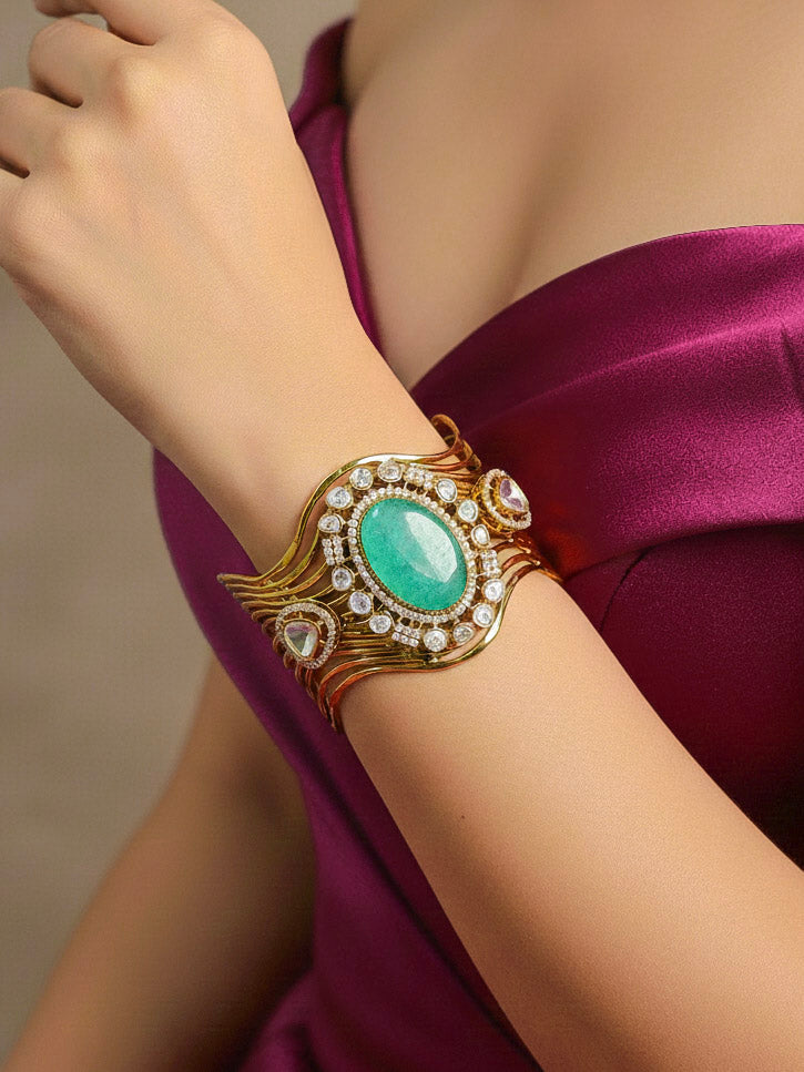 Close-up of a woman wearing an ornate traditional Mint Green (gold Polish) Colored Stone Bracelet with American Diamond, Colored Stones and Kundan. Festive outfit paired with a premium imitation Colored Stone bracelet in India. Wedding guest wearing a minimal artificial Colored Stone bracelet.