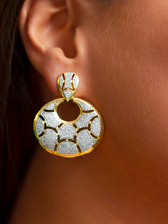 Close-up of a woman wearing an ornate Western (Gold Polish) Diamond Earrings with American Diamond. Cocktail party outfit paired with sparkling artificial American Diamond earrings. Elegant party wear styled with high-quality imitation American Diamond earrings. 