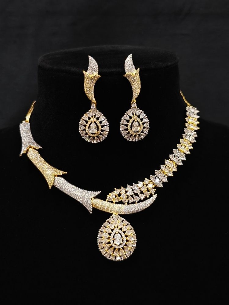 Close-up of an ornate Western (Dual Tone) Gold & Silver Collar jewellery set and earrings with American Diamond. Party wear outfit completed with a lightweight American diamond necklace. Close-up of a cocktail party look featuring a premium American diamond necklace.