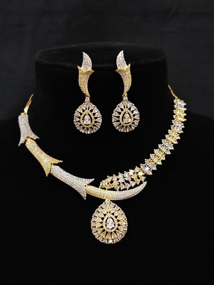 Close-up of an ornate Western (Dual Tone) Gold & Silver Collar jewellery set and earrings with American Diamond. Party wear outfit completed with a lightweight American diamond necklace. Close-up of a cocktail party look featuring a premium American diamond necklace.