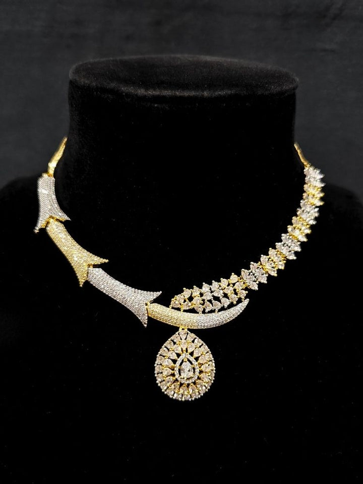 Close-up of an ornate Western (Dual Tone) Gold & Silver Collar jewellery set and earrings with American Diamond. Party wear outfit completed with a lightweight American diamond necklace. Close-up of a cocktail party look featuring a premium American diamond necklace.