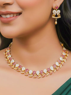 Close-up of a woman wearing an ornate Traditional Pink & White (Gold Polish)  Collar Necklace Set and earrings with American Diamonds and Colored Stones. Mehendi function outfit styled with a lightweight Diamond necklace. Wedding guest styling a statement American Diamond artificial necklace.