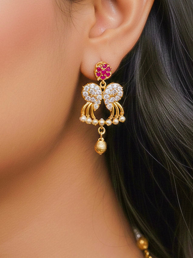 Close-up of a woman wearing an ornate Traditional Pink & White (Gold Polish)  Collar Necklace Set and earrings with American Diamonds and Colored Stones. Mehendi function outfit styled with a lightweight Diamond necklace. Wedding guest styling a statement American Diamond artificial necklace.