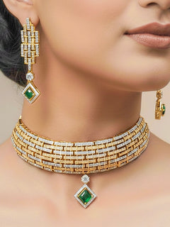 Close-up of a woman wearing an ornate Indo-Western American Diamond gold & Silver Choker jewellery set and earrings with American Diamond and Green Colored Stones. Woman wearing anti-tarnish artificial American Diamond Necklace Set for long functions. Perfect American Diamond necklace set for weddings and festivals.