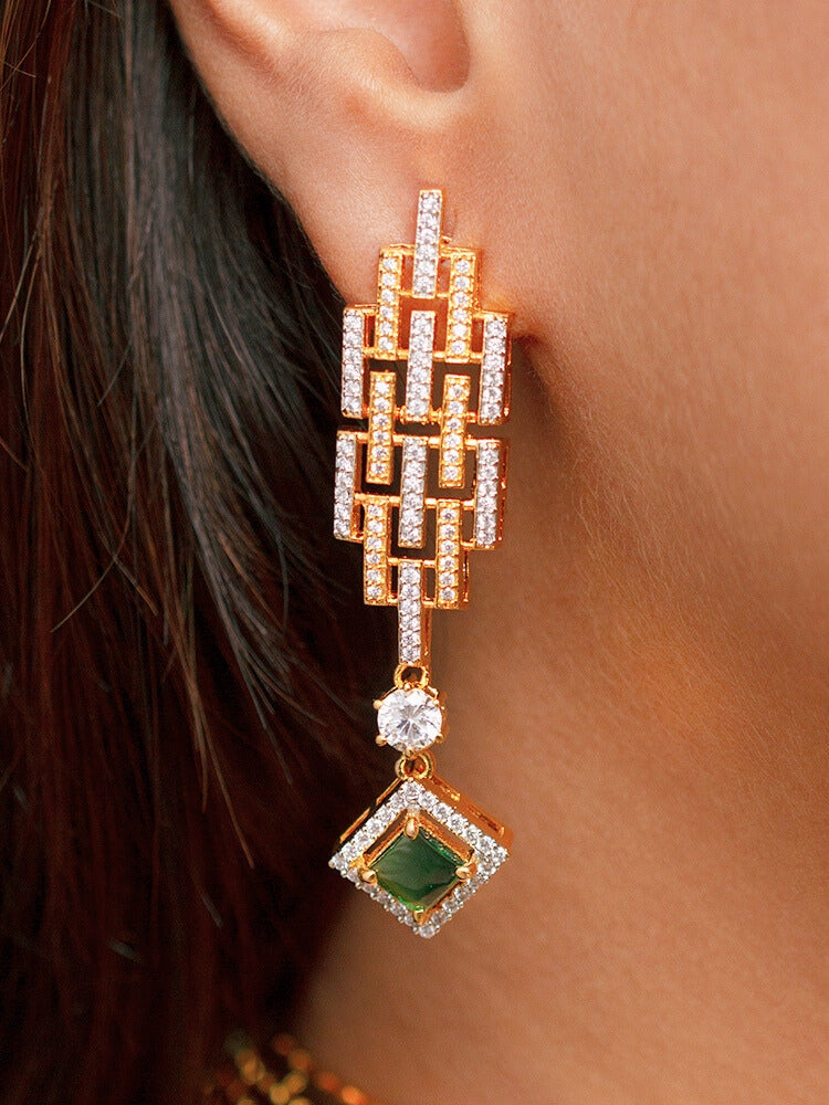 A woman in a traditional saree, wearing a gorgeous artificial diamond choker necklace with emerald green colored stone paired with diamond earrings. This artificial diamond jewelry set offers a traditional yet modern touch for Indian brides, designed to add elegance and sophistication to any occasion.