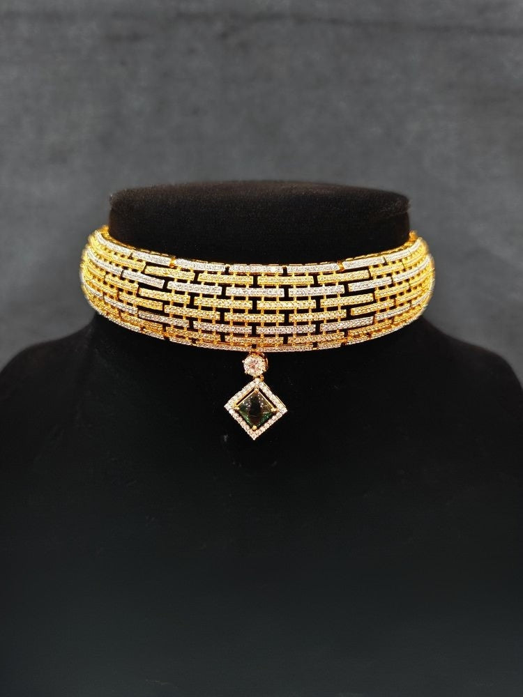 Close-up of an ornate Indo-Western American Diamond gold & Silver Choker jewellery set and earrings with American Diamond and Green Colored Stones. Anti-tarnish artificial American Diamond Necklace Set for long functions. Perfect American Diamond necklace set for weddings and festivals.