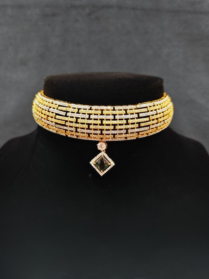 Close-up of an ornate Indo-Western American Diamond gold & Silver Choker jewellery set and earrings with American Diamond and Green Colored Stones. Anti-tarnish artificial American Diamond Necklace Set for long functions. Perfect American Diamond necklace set for weddings and festivals.