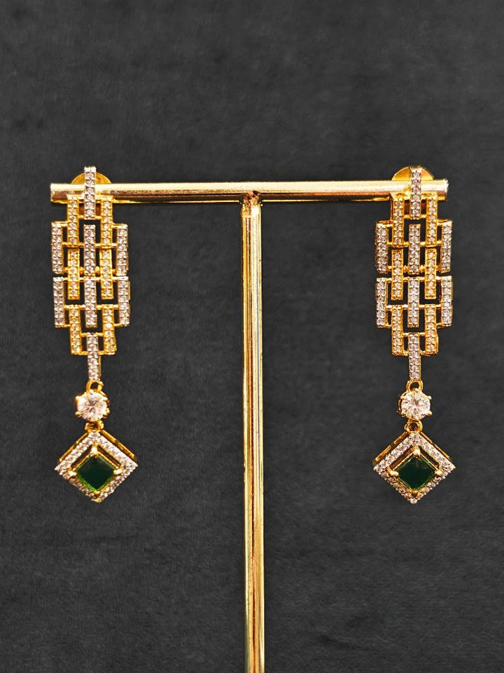 Close-up of an ornate Indo-Western American Diamond gold & Silver Choker jewellery set and earrings with American Diamond and Green Colored Stones. Anti-tarnish artificial American Diamond Necklace Set for long functions. Perfect American Diamond necklace set for weddings and festivals.