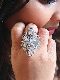 Close-up of a woman wearing an ornate Western (Silver Polish) White Ring with American Dimonds. Close-up of a cocktail party look featuring a premium American diamond Ring. Reception-ready look featuring a statement American diamond Ring.