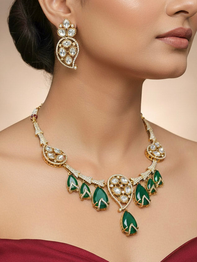 "A stunning woman wearing a glamorous artificial diamond and polki and green colored stone necklace paired with chic earrings, perfect for bridal wear. This high-quality artificial diamond jewelry set is the ideal choice for modern brides looking for a budget-friendly option with timeless sparkle."
