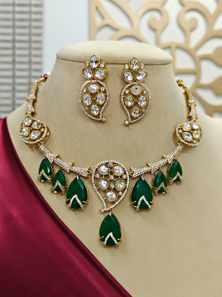 "A bride-to-be wearing an exquisite artificial diamond, polki and green colored stone necklace and matching earrings, designed for the perfect engagement look. This stunning artificial diamond jewelry set offers luxury and sophistication while being an affordable alternative to natural diamonds."
