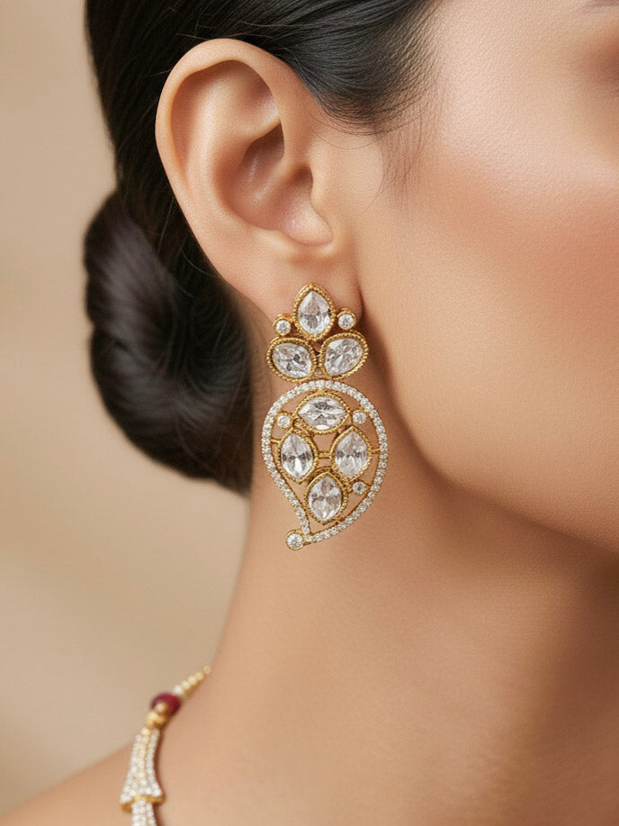 "A stunning woman wearing a glamorous artificial diamond and red colored stone  necklace paired with chic earrings, perfect for bridal wear. This high-quality artificial diamond jewelry set is the ideal choice for modern brides looking for a budget-friendly option with timeless sparkle."
