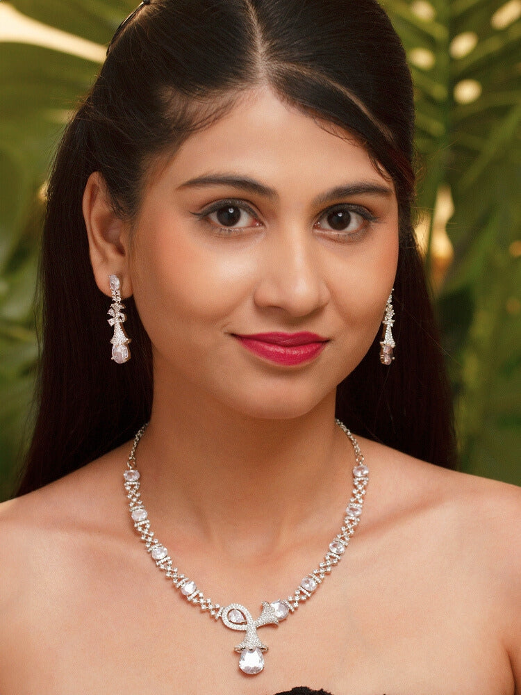 A beautiful woman wearing an elegant artificial diamond necklace and matching earrings. This premium artificial diamond jewelry set is perfect for special occasions, from Indian weddings to engagement parties, offering sophisticated glamour without the high price tag.