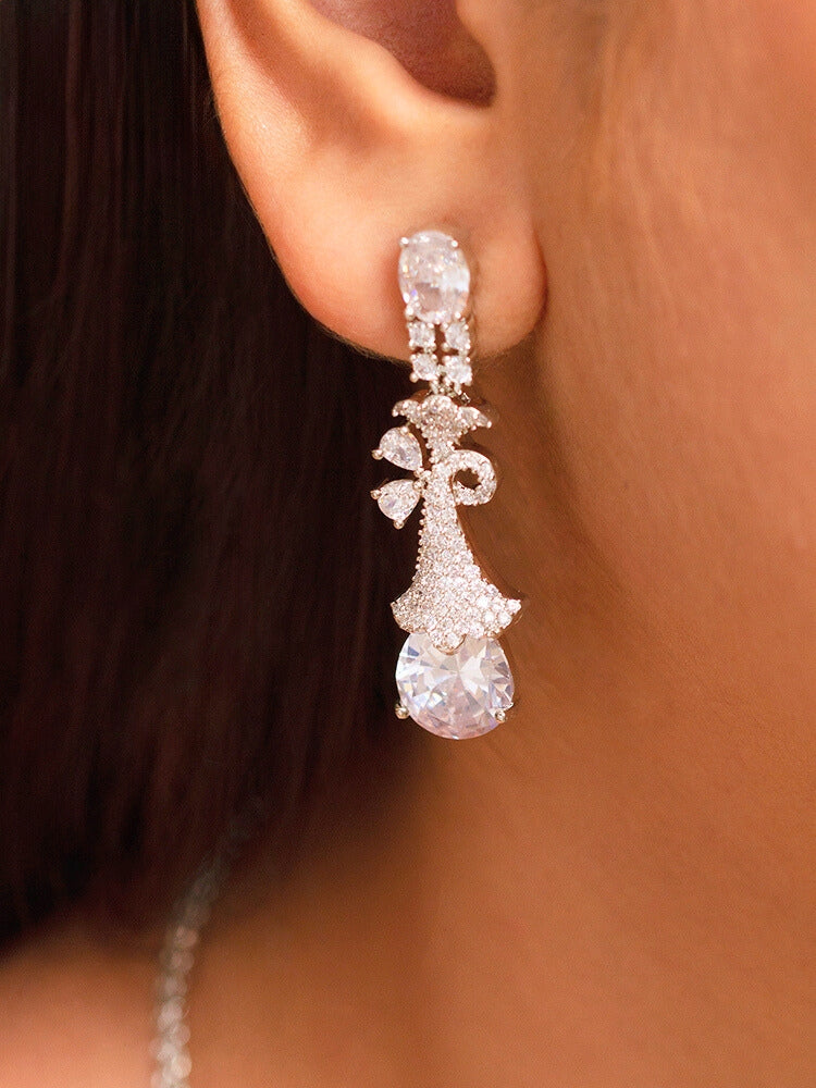 Close-up of a woman wearing a stunning affordable artificial diamond necklace and matching earrings set, perfect for wedding guests and formal events. This luxury artificial diamond jewelry provides the brilliance of real diamonds at a fraction of the cost.