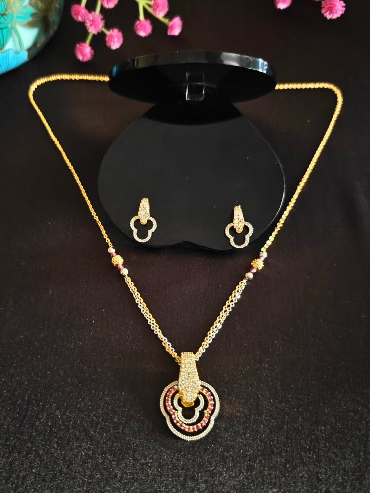 Close-up of an ornate Indo-Western (Gold Polish) Multi-Color Diamond Pendant Set with American Diamond and Colored Stones. Close-up of a bridal look featuring an anti-tarnish American diamond artificial Pendant Set. Elegant festive look with a high-quality imitation American diamond Pendant set.