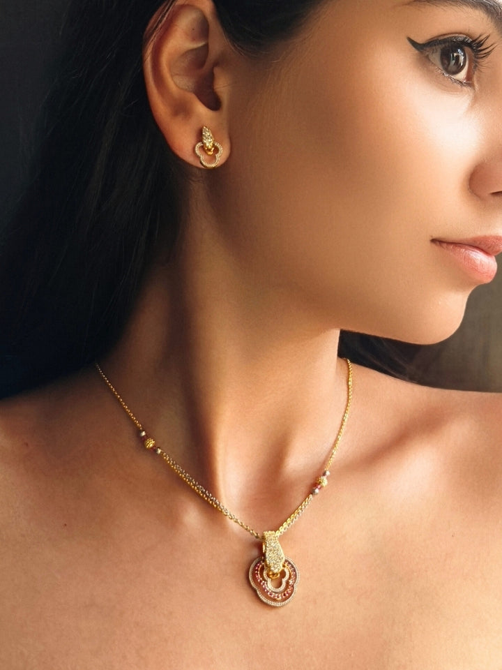Close-up of a women wearing an ornate Indo-Western (Gold Polish) Multi-Color Diamond Pendant Set with American Diamond and Colored Stones. Close-up of a bridal look featuring an anti-tarnish American diamond artificial Pendant Set. Elegant festive look with a high-quality imitation American diamond Pendant set.