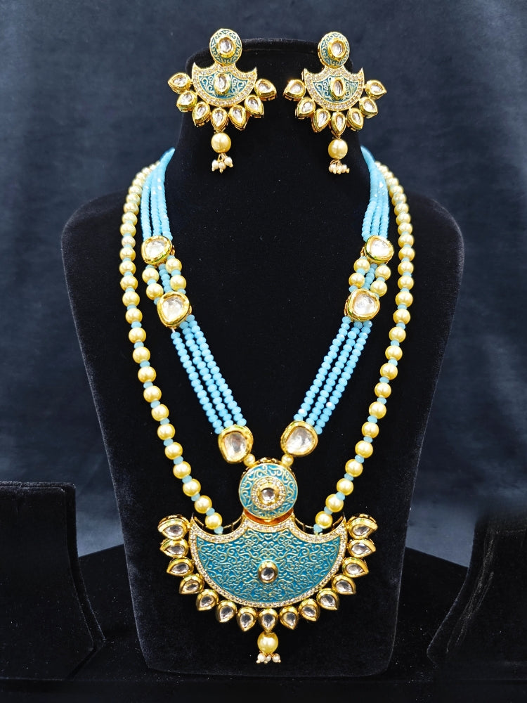 Close-up of an ornate traditional Mint Blue Meenakari Long  jewellery set and earrings with Kundan, Meenakari work, crystal beads, pearls and American Diamond. Close-up of enamel work in Meenakari artificial wedding jewelry. Perfect Meenakari necklace set for weddings and festivals.