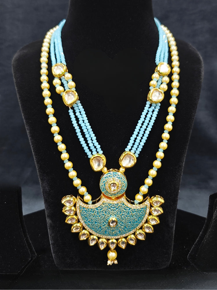 Close-up of an ornate traditional Mint Blue Meenakari Long  jewellery set and earrings with Kundan, Meenakari work, crystal beads, pearls and American Diamond. Close-up of enamel work in Meenakari artificial wedding jewelry. Perfect Meenakari necklace set for weddings and festivals.