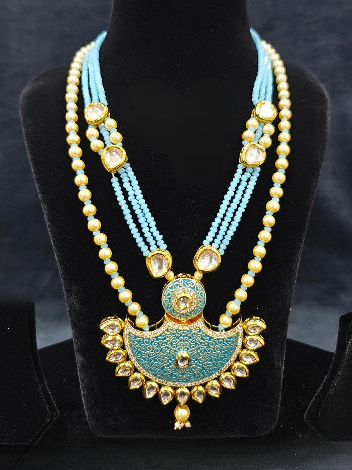 Close-up of an ornate traditional Mint Blue Meenakari Long  jewellery set and earrings with Kundan, Meenakari work, crystal beads, pearls and American Diamond. Close-up of enamel work in Meenakari artificial wedding jewelry. Perfect Meenakari necklace set for weddings and festivals.