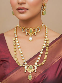 Close-up of a woman wearing an ornate traditional (Gold Polish) Mint Green Long Kundan jewellery set and earrings and a Choker and Mangtikka with Kundan and Colored Stones. Wedding celebration look enhanced with a statement Kundan necklace. Bride wearing a royal Kundan artificial necklace for wedding rituals.