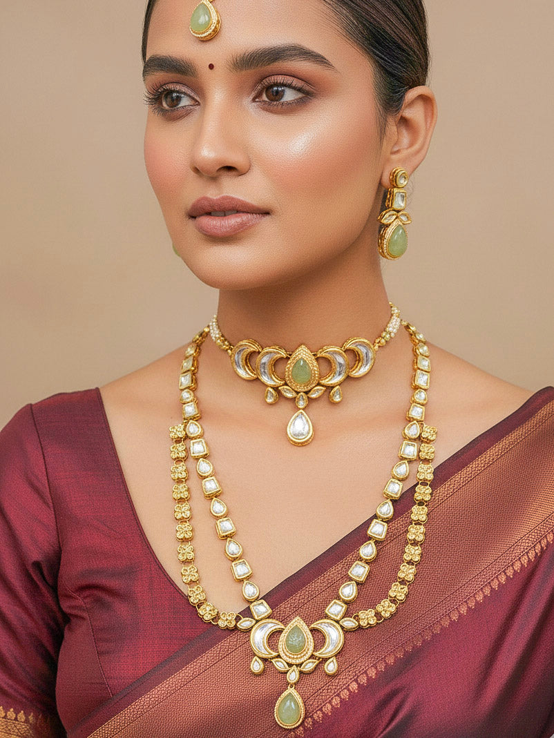 Close-up of a woman wearing an ornate traditional (Gold Polish) Mint Green Long Kundan jewellery set and earrings and a Choker and Mangtikka with Kundan and Colored Stones. Wedding celebration look enhanced with a statement Kundan necklace. Bride wearing a royal Kundan artificial necklace for wedding rituals.