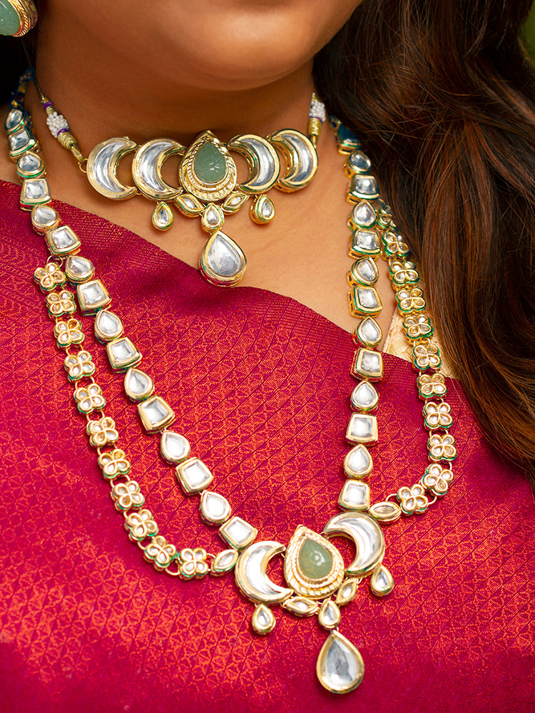 Close-up of a woman wearing an ornate traditional (Gold Polish) Mint Green Long Kundan jewellery set and earrings and a Choker and Mangtikka with Kundan and Colored Stones. Wedding celebration look enhanced with a statement Kundan necklace. Bride wearing a royal Kundan artificial necklace for wedding rituals.