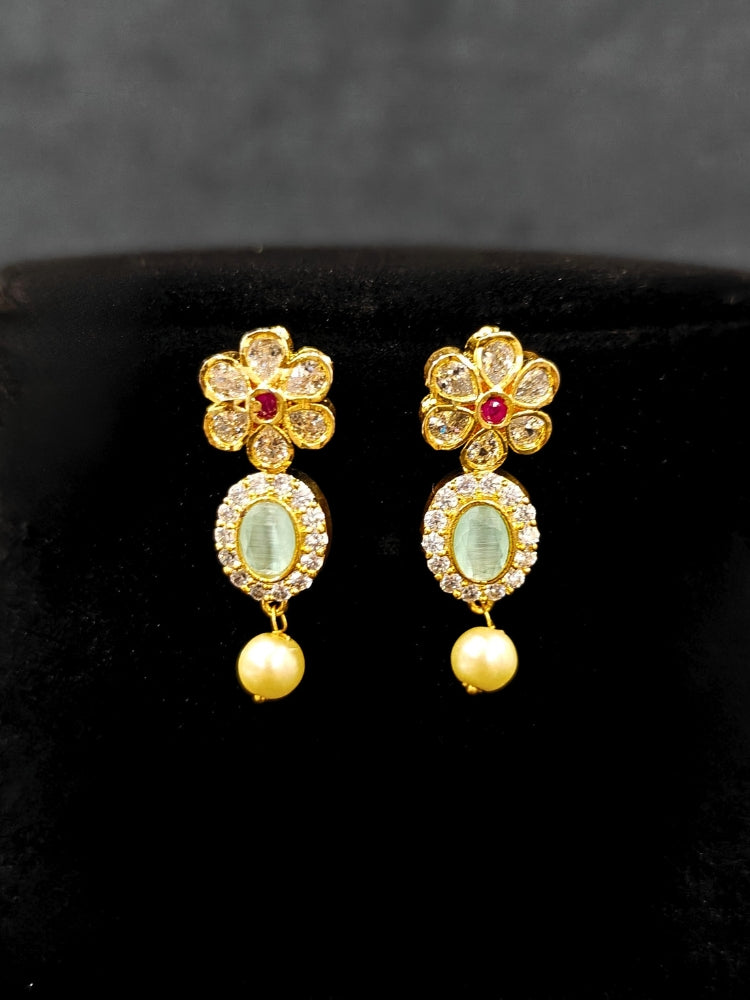 Close-up of an ornate traditional Mint Green (gold Polish) Collar jewellery set and earrings with American diamonds, Pearls and Colored Stones. Festive Diwali outfit styled with an American diamond artificial necklace. Elegant wedding jewelry look featuring a premium artificial American diamond necklace. 