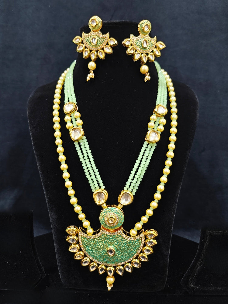 Close-up of an ornate traditional Mint Green Meenakari Long  jewellery set and earrings with Kundan, Meenakari work, crystal beads, pearls and American Diamond. Close-up of enamel work in Meenakari artificial wedding jewelry. Perfect Meenakari necklace set for weddings and festivals.