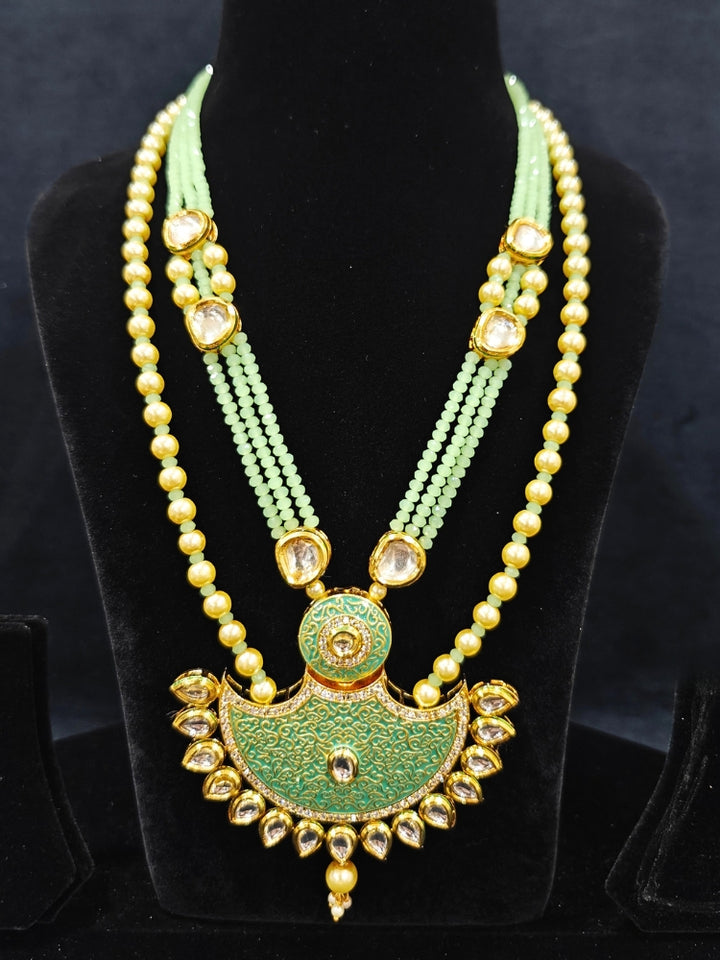 Close-up of an ornate traditional Mint Green Meenakari Long  jewellery set and earrings with Kundan, Meenakari work, crystal beads, pearls and American Diamond. Close-up of enamel work in Meenakari artificial wedding jewelry. Perfect Meenakari necklace set for weddings and festivals.
