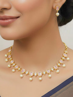 Close-up of a woman wearing an ornate traditional (Gold Polish) Mint Pink Choker jewellery set and earrings with Colored Stones, Pearl and American Diamonds. Festive Diwali outfit styled with an Colored Stones artificial necklace. Mehendi function outfit styled with a Colored Stone  necklace set.
