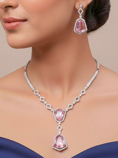 Close-up of a woman wearing an ornate Western Mint Pink (Silver Polish) Diamond jewellery set and earrings with American Diamond and Colored Stones. Festive Diwali outfit styled with an American diamond artificial necklace. Close-up of a party look featuring a premium American diamond necklace.