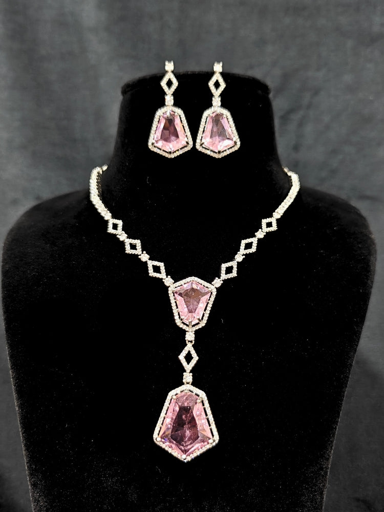 Close-up of an ornate Western Mint Pink (Silver Polish) Diamond jewellery set and earrings with American Diamond and Colored Stones. Festive Diwali outfit styled with an American diamond artificial necklace. Close-up of a party look featuring a premium American diamond necklace.