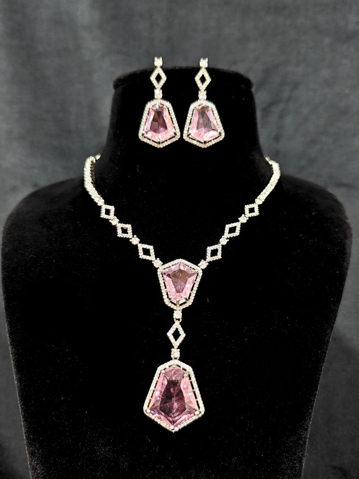 Close-up of an ornate Western Mint Pink (Silver Polish) Diamond jewellery set and earrings with American Diamond and Colored Stones. Festive Diwali outfit styled with an American diamond artificial necklace. Close-up of a party look featuring a premium American diamond necklace.