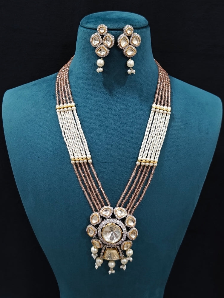 Close-up of an ornate traditional Mint Pink Long jewellery set and earrings with Kundan, American Diamond, pearls and Crystal Beads. Mehendi ceremony look completed with a handcrafted Kundan jewelry set. Wedding guest wearing a lightweight Kundan necklace for a Wedding function.